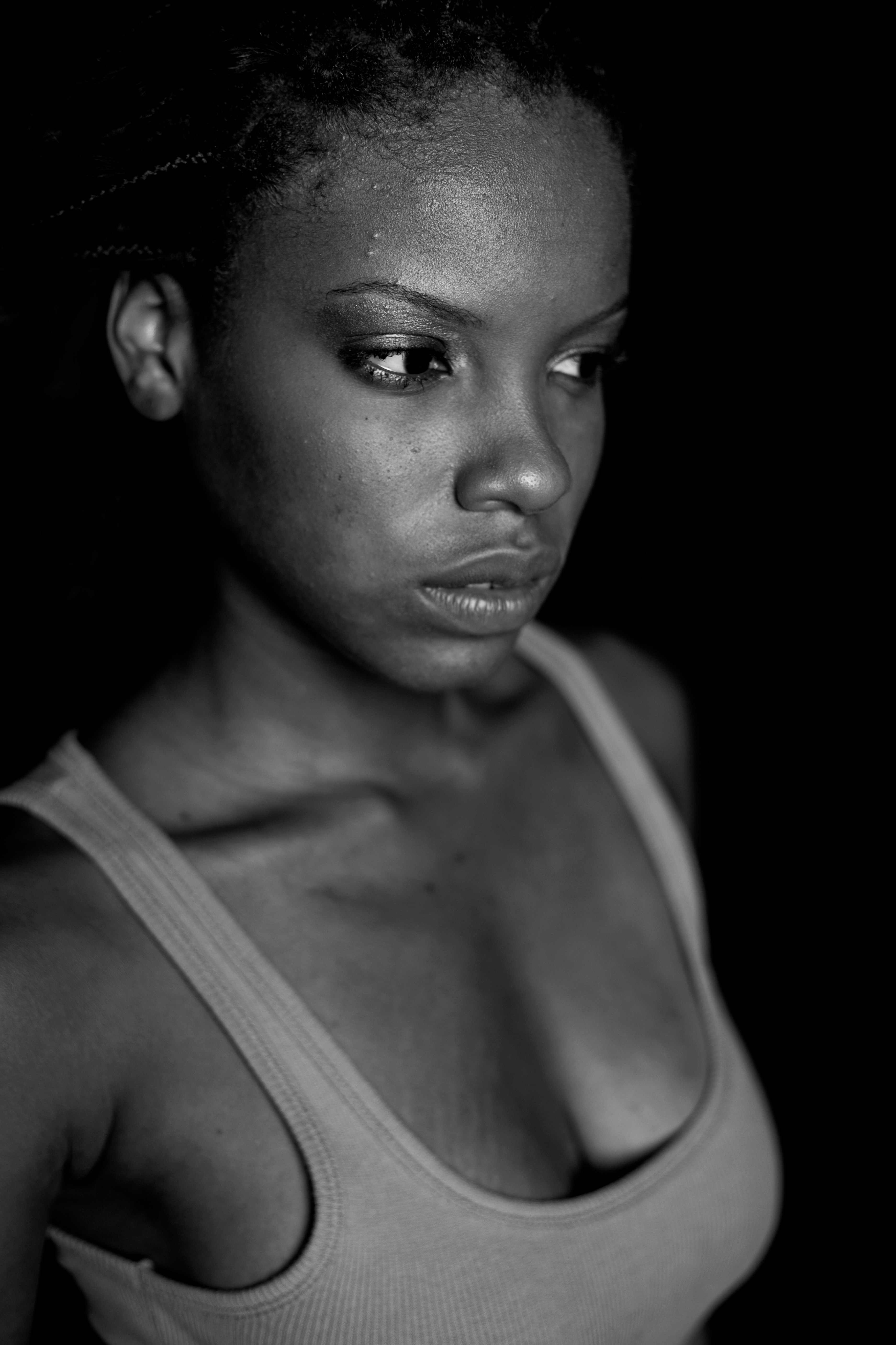 woman in tank top wearing black hat